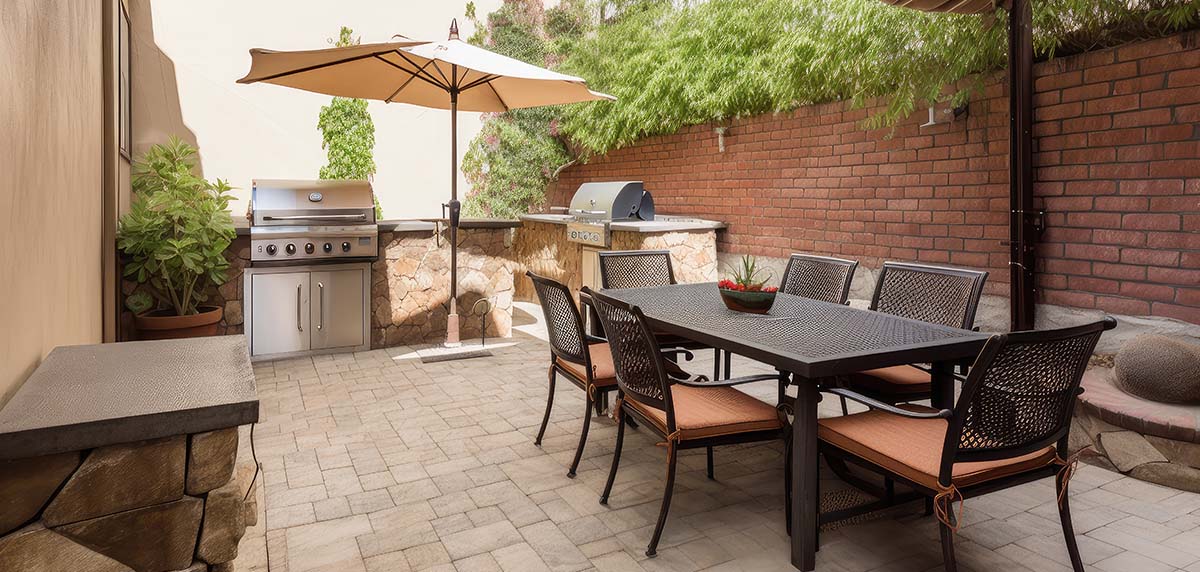 Patio with BBQs and dining area for guests